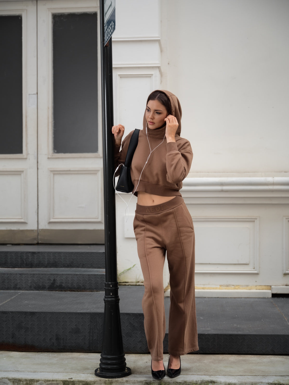 Street-style look of the AEDIA Funnel Hoodie in Double Shot