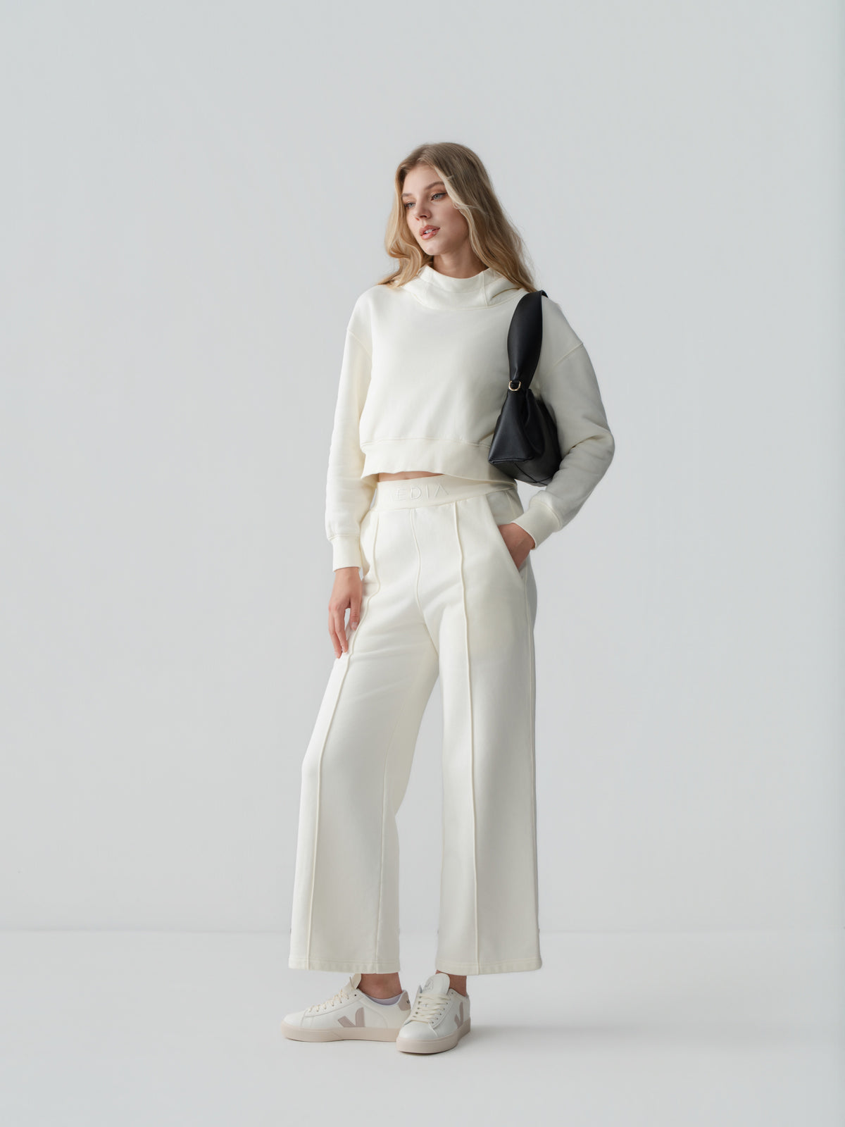 Model wearing the AEDIA Wide Leg Pants in Milk